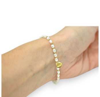 Bracelet élastique fin en perles blanches et dorées